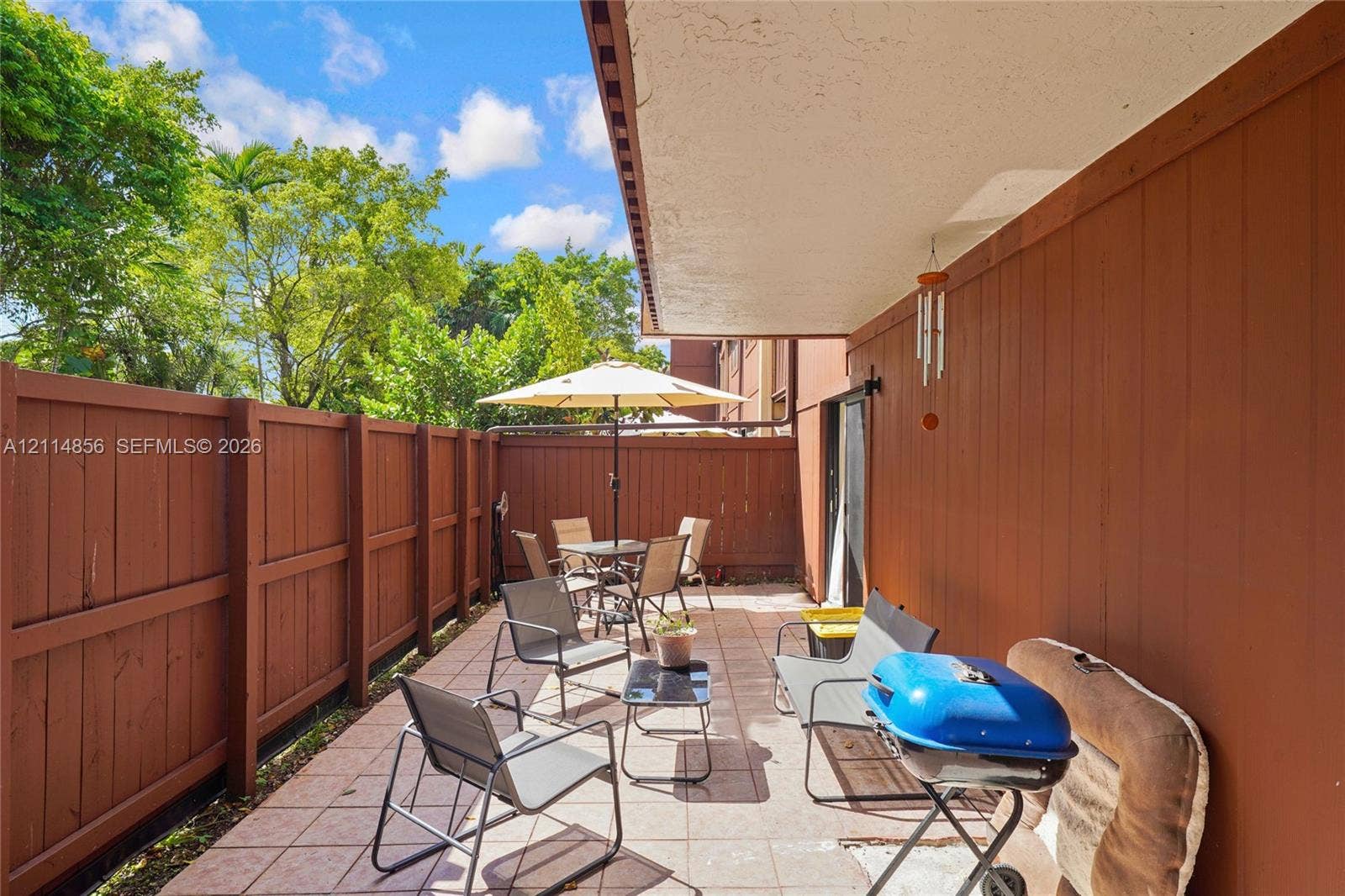 Miami, FL 33173 Covered patio featuring tiled flooring and a wood-slat privacy fence