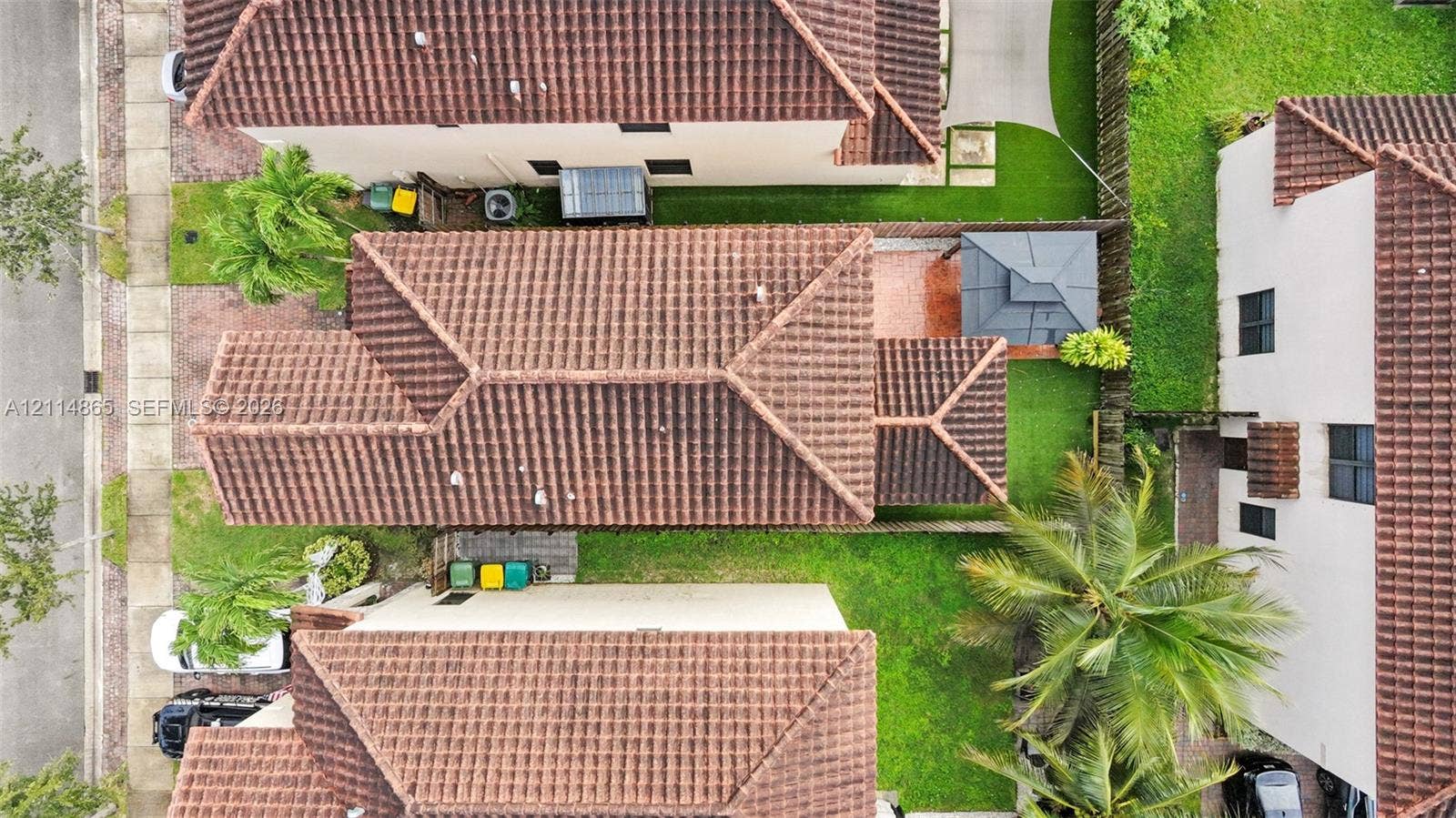 3754 NE 2nd Street, Homestead, FL 33033 Aerial perspective featuring a tile roof, concrete driveway, and maintained lawn area