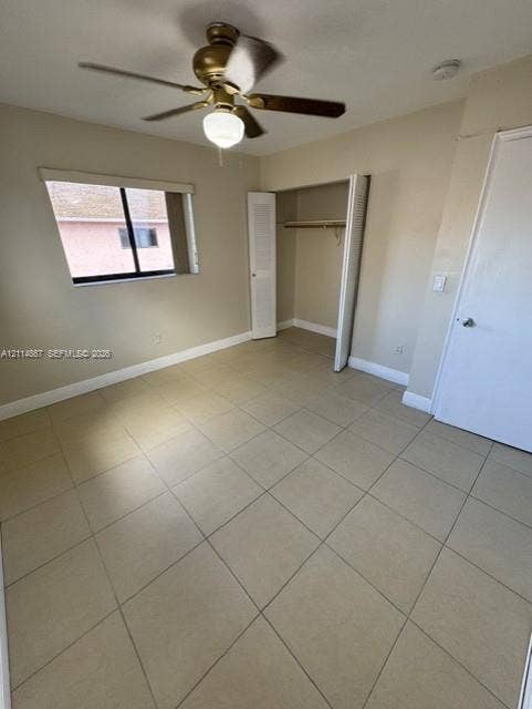 1663 W 41st Street, #1663, Hialeah, Hialeah, FL 33012 Neutral-toned ceramic tile flooring, ceiling fan with light fixture, single-panel interior door, and built-in closet with louvered double doors