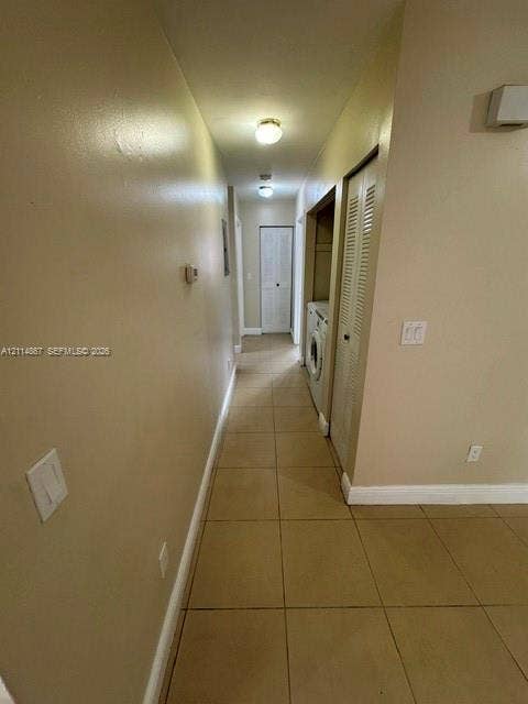 1663 W 41st Street, #1663, Hialeah, Hialeah, FL 33012 Hallway featuring large-format tile flooring, flush-mount ceiling lighting, and a closet with louvered bi-fold doors
