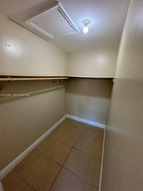 1663 W 41st Street, #1663, Hialeah, Hialeah, FL 33012 Storage space featuring tile flooring, built-in shelving, and a garment rod
