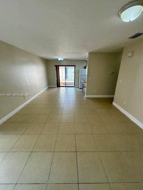 1663 W 41st Street, #1663, Hialeah, Hialeah, FL 33012 Open floor plan featuring ceramic tile flooring, neutral wall tones, ceiling-mounted lighting, and a glass sliding door