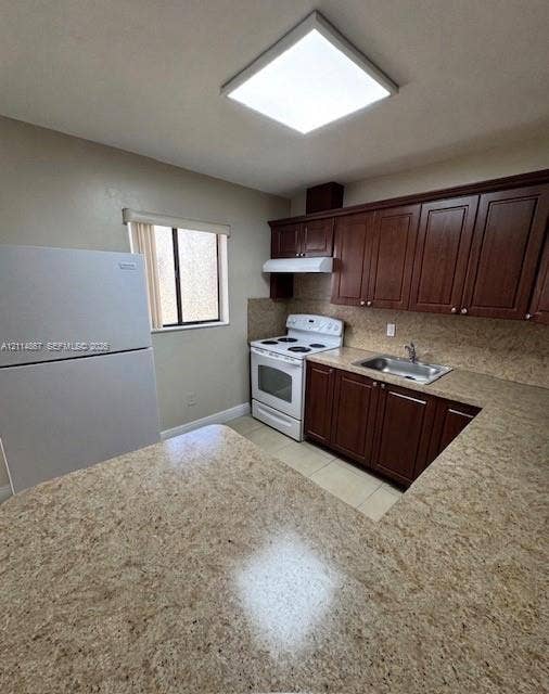1663 W 41st Street, #1663, Hialeah, Hialeah, FL 33012 Kitchen featuring wood cabinetry, stone-finish countertops, stainless steel sink, tile flooring, and flush-mount lighting