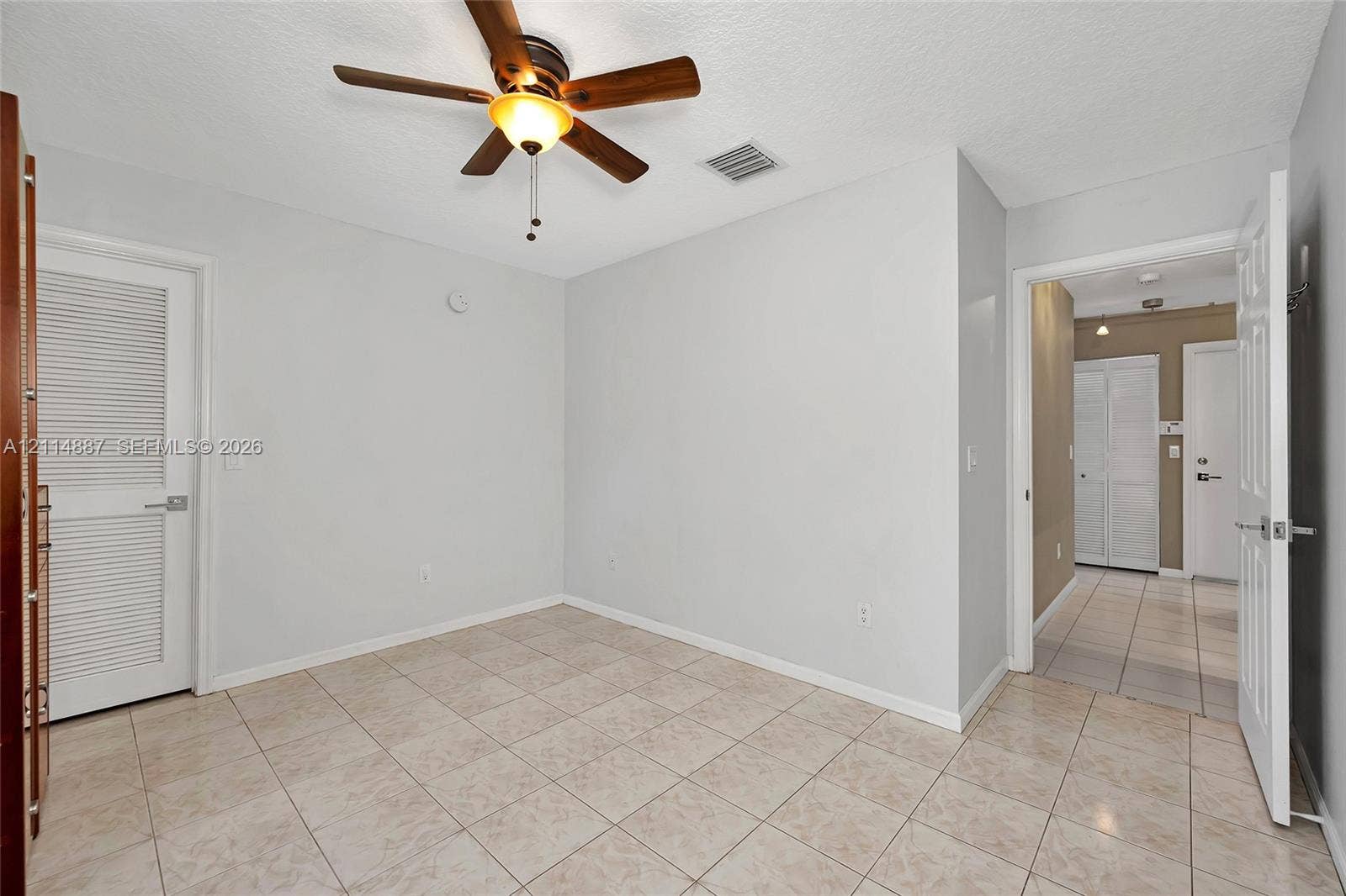 5722 Aspen Ridge Circle, Delray Beach, FL 33484 Ceramic tile flooring, ceiling fan with integrated lighting, and louvered closet door