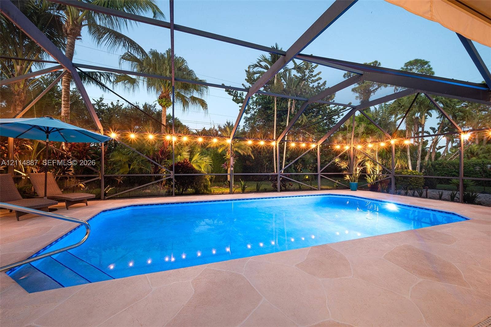 5722 Aspen Ridge Circle, Delray Beach, FL 33484 Screened-in outdoor swimming pool with stone-finish decking and built-in steps