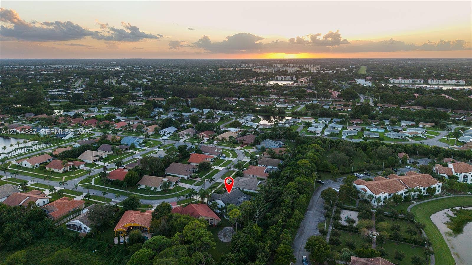 5722 Aspen Ridge Circle, Delray Beach, FL 33484 Aerial perspective of a residential property featuring a tiled roof and mature perimeter landscaping