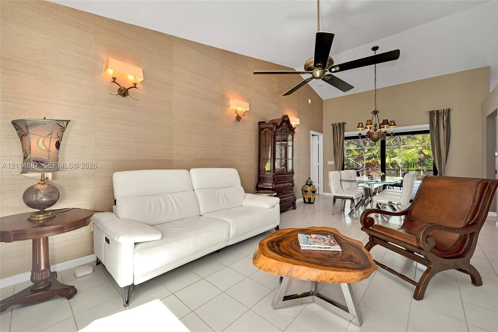 5722 Aspen Ridge Circle, Delray Beach, FL 33484 Vaulted ceiling featuring a central multi-blade ceiling fan, textured wall covering, and recessed lighting