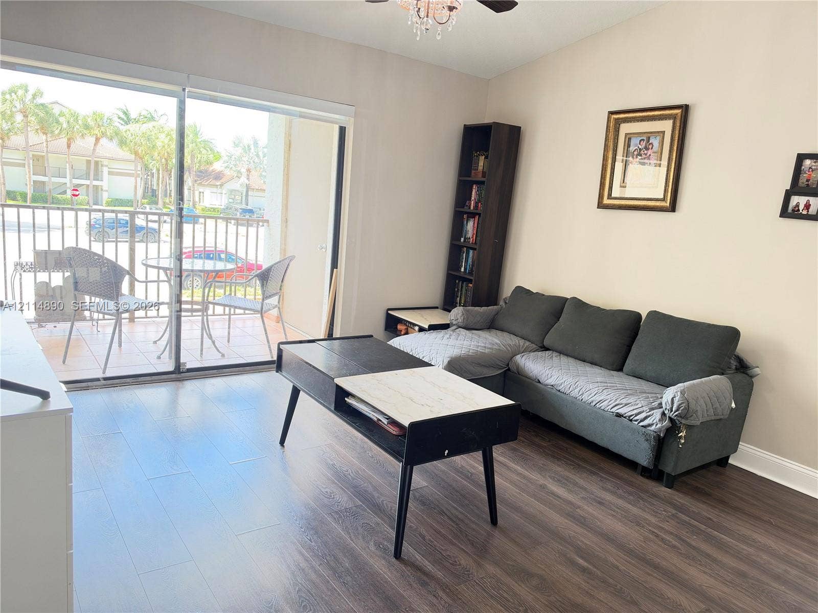 610 S Park Road, #28-1, Hollywood, FL 33021 Wood-finish flooring, sliding glass patio door, ceiling-mounted light fixture, and tiled exterior balcony