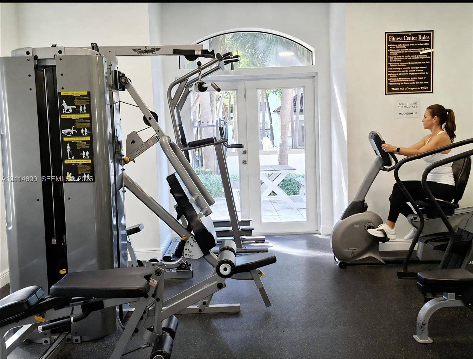 610 S Park Road, #28-1, Hollywood, FL 33021 Fitness center featuring industrial-grade weight training equipment, cardio machines, resilient rubber flooring, and arched double-glass entry doors