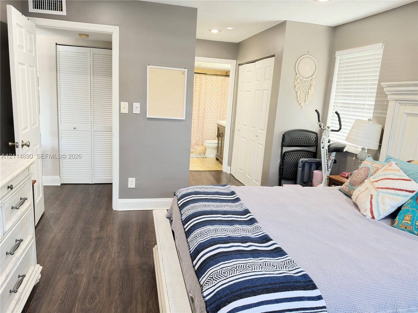 610 S Park Road, #28-1, Hollywood, FL 33021 Bedroom featuring wood-finish flooring, two sets of louvered bifold closet doors, recessed lighting, and horizontal blinds