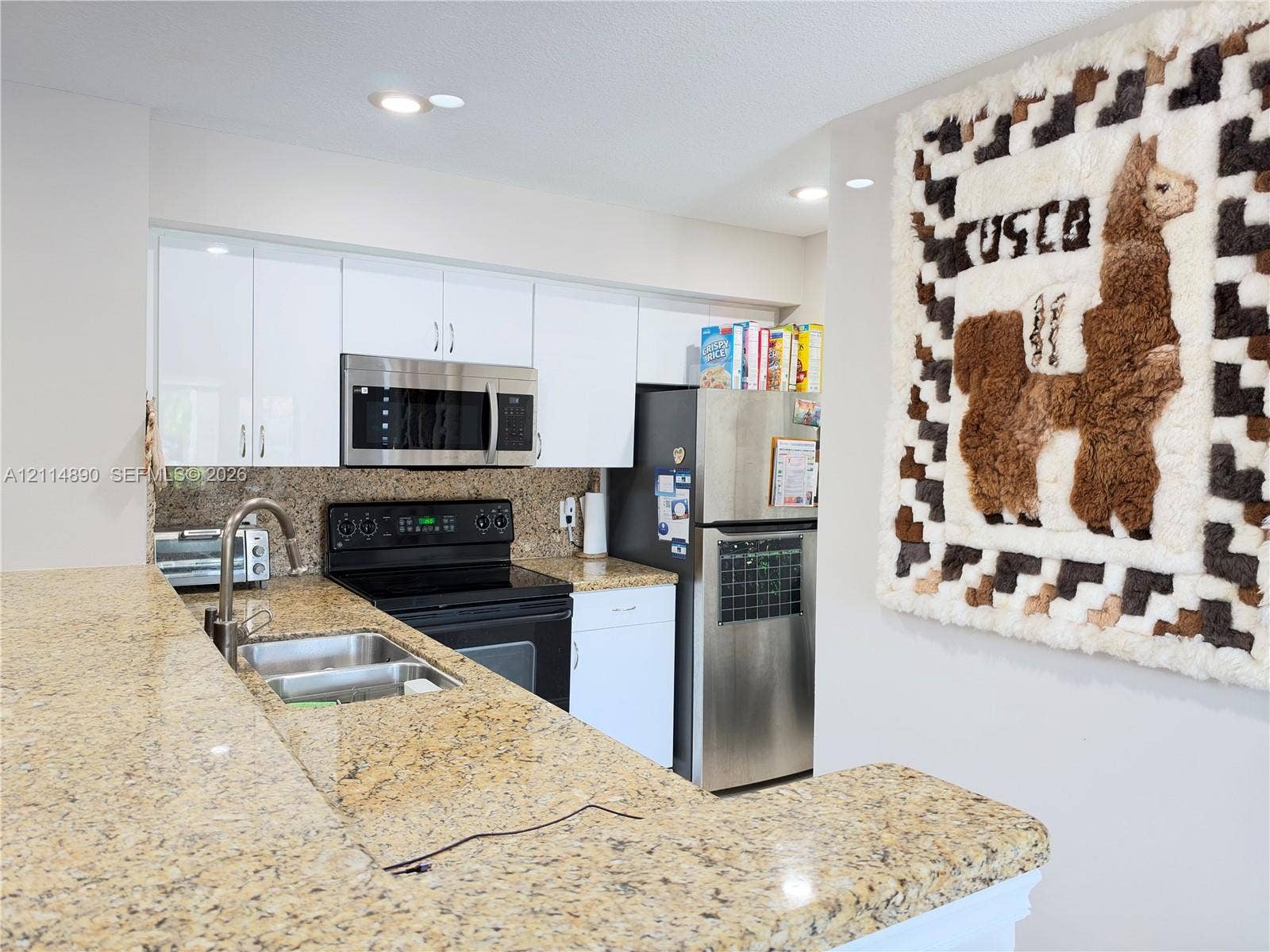 610 S Park Road, #28-1, Hollywood, FL 33021 Kitchen featuring white cabinetry, stone countertops, stainless steel appliances, and a dual-basin sink with a goose-neck faucet