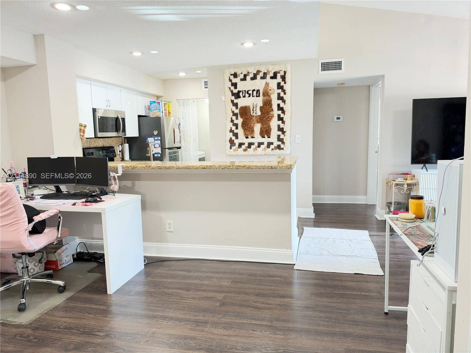 610 S Park Road, #28-1, Hollywood, FL 33021 Kitchen featuring white cabinetry, stone-finish countertops, stainless steel microwave, and recessed ceiling lighting over wood-finish flooring