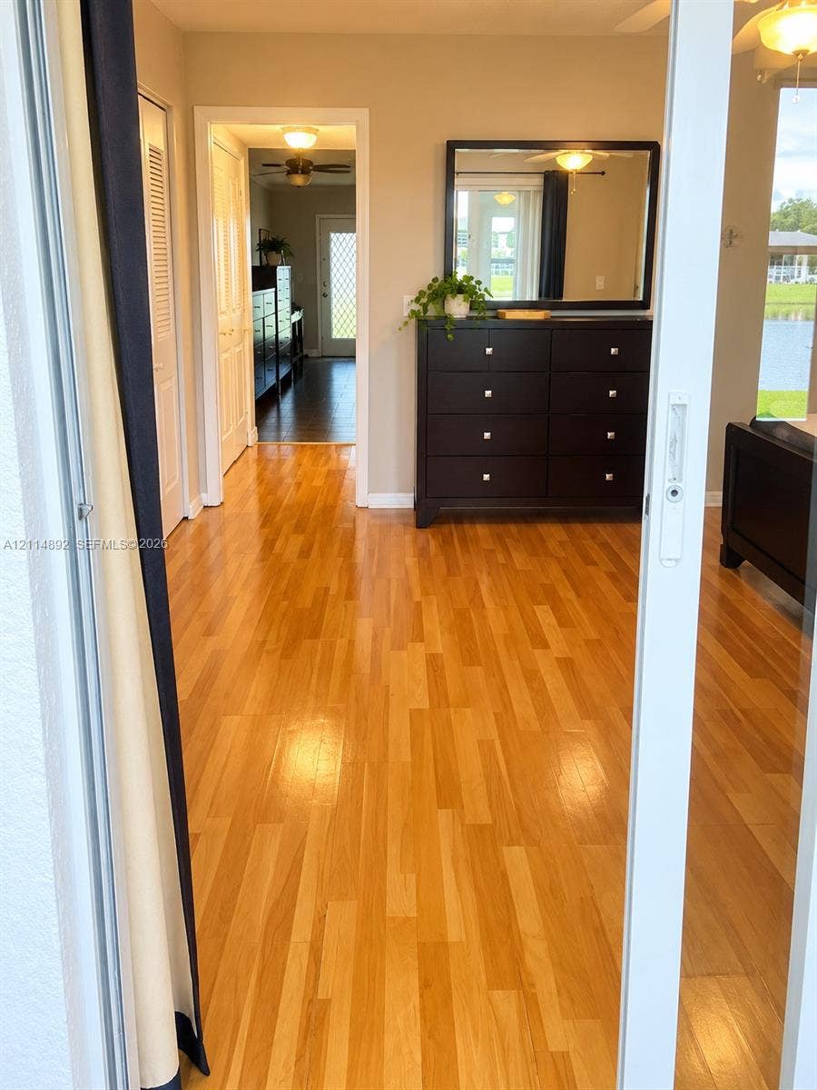 582 Durham U, #582, Deerfield Beach, FL 33442 Wood-finish flooring, white sliding glass door, and interior paneled doors