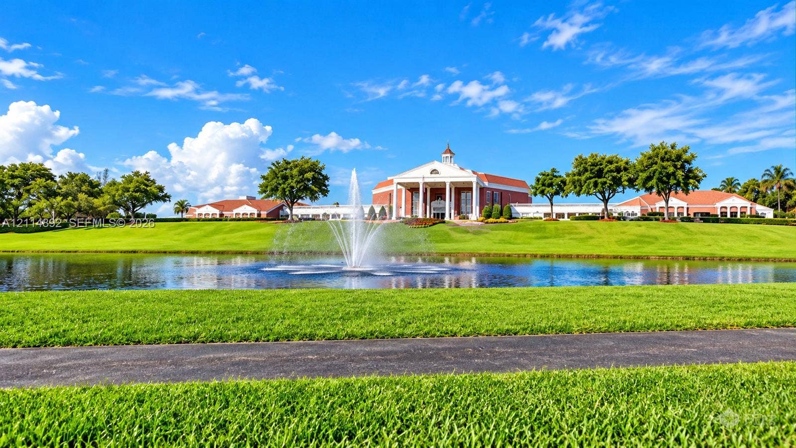 582 Durham U, #582, Deerfield Beach, FL 33442 Grand architectural exterior featuring a pedimented facade, prominent central columns, a cupola, and extensive manicured grounds surrounding a central water feature with a fountain