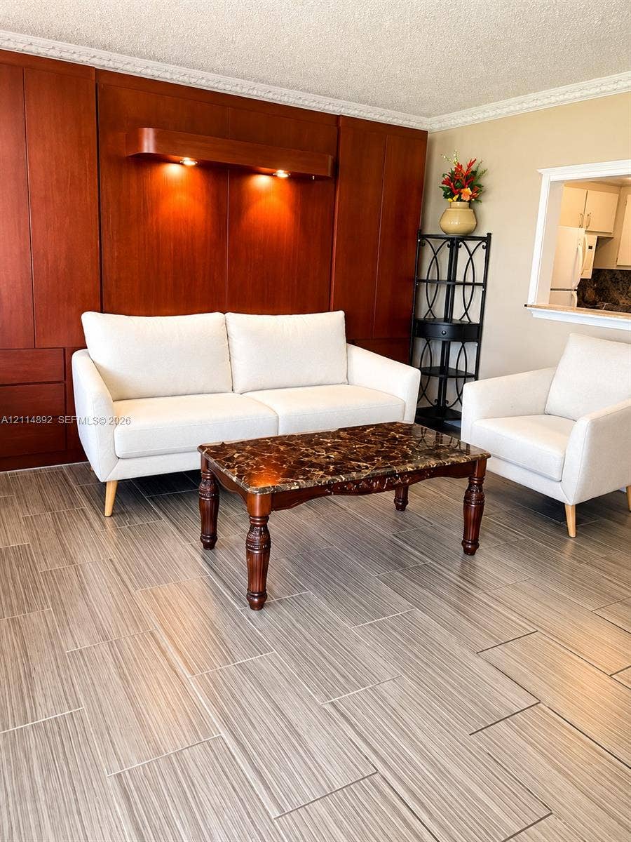 582 Durham U, #582, Deerfield Beach, FL 33442 Floor-to-ceiling wood cabinetry featuring integrated recessed lighting, ceramic tile flooring, and a decorative crown molding finish