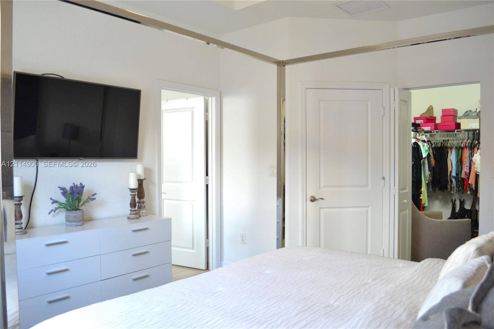 25048 SW 113th Place, Homestead, FL 33032 Interior space featuring white paneled doors, mirrored wall trim, and a dedicated walk-in closet with built-in wire shelving