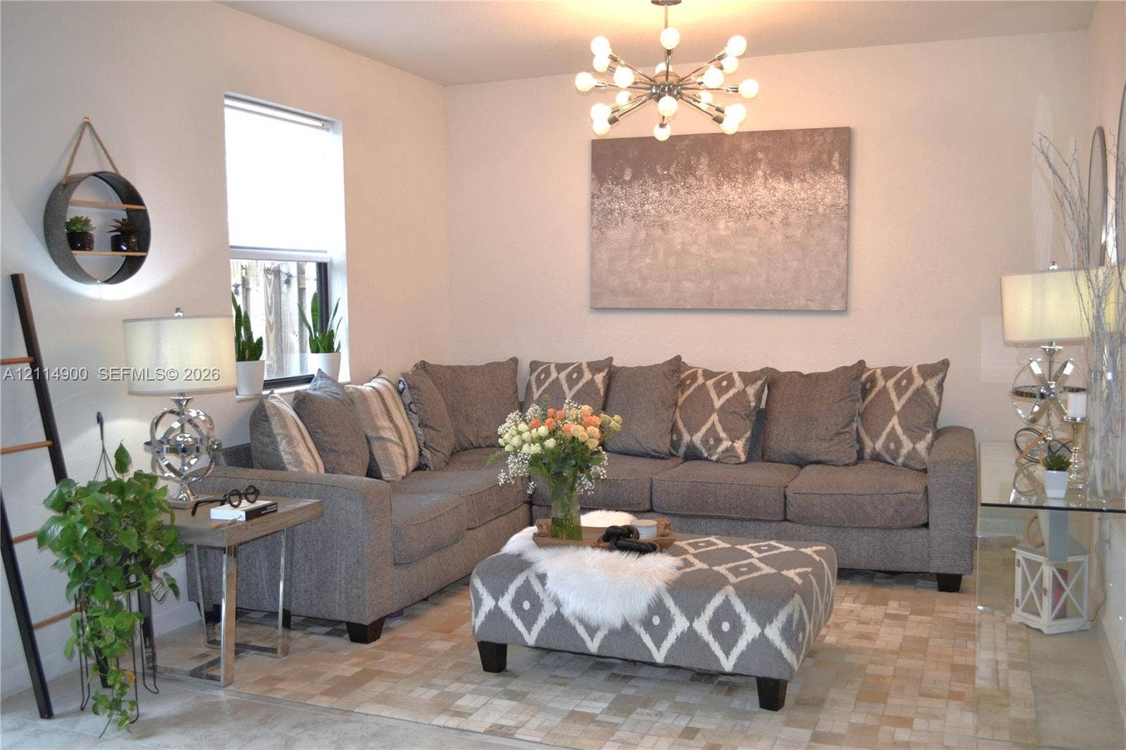 25048 SW 113th Place, Homestead, FL 33032 Modern multi-bulb sputnik chandelier, neutral wall finish, and natural light via a single-pane window