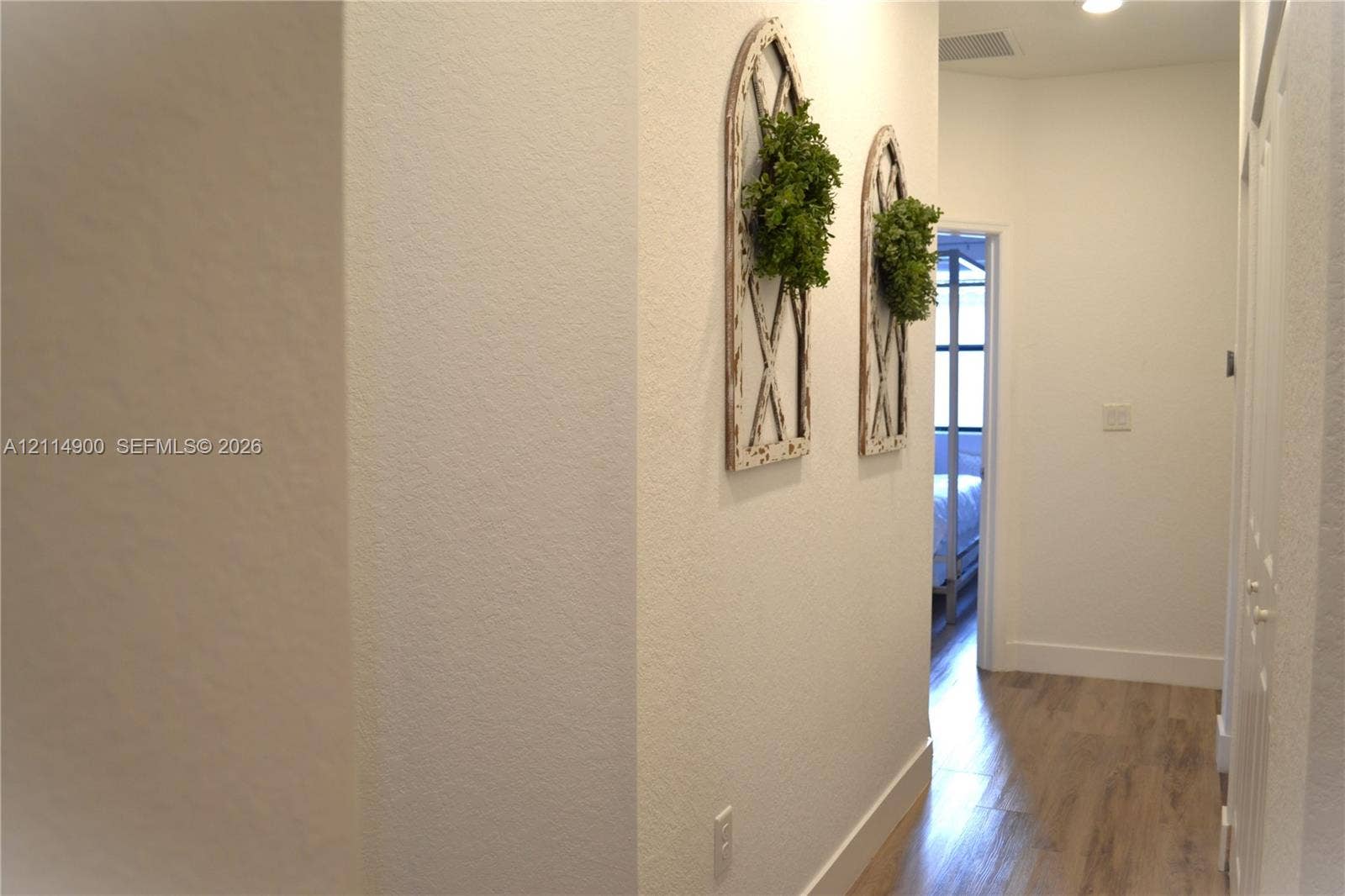 25048 SW 113th Place, Homestead, FL 33032 Hallway featuring wood-finish flooring, smooth-textured walls, and recessed ceiling lighting