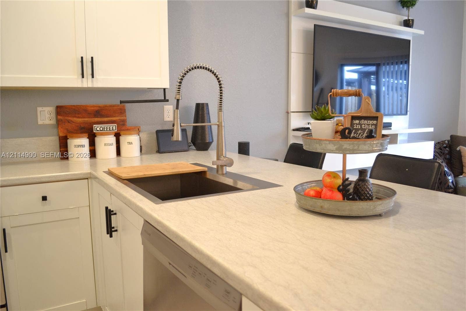 25048 SW 113th Place, Homestead, FL 33032 Kitchen featuring white shaker-style cabinetry, a stone-finish countertop, an undermount sink with a gooseneck industrial faucet, a built-in dishwasher, and a wall-mounted display shelf