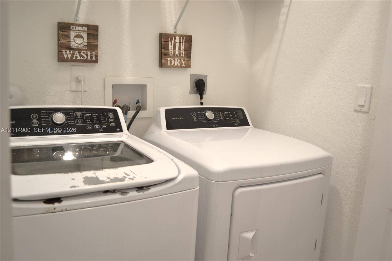 25048 SW 113th Place, Homestead, FL 33032 Laundry alcove featuring recessed water supply connections, dedicated electrical outlets, and built-in upper shelving