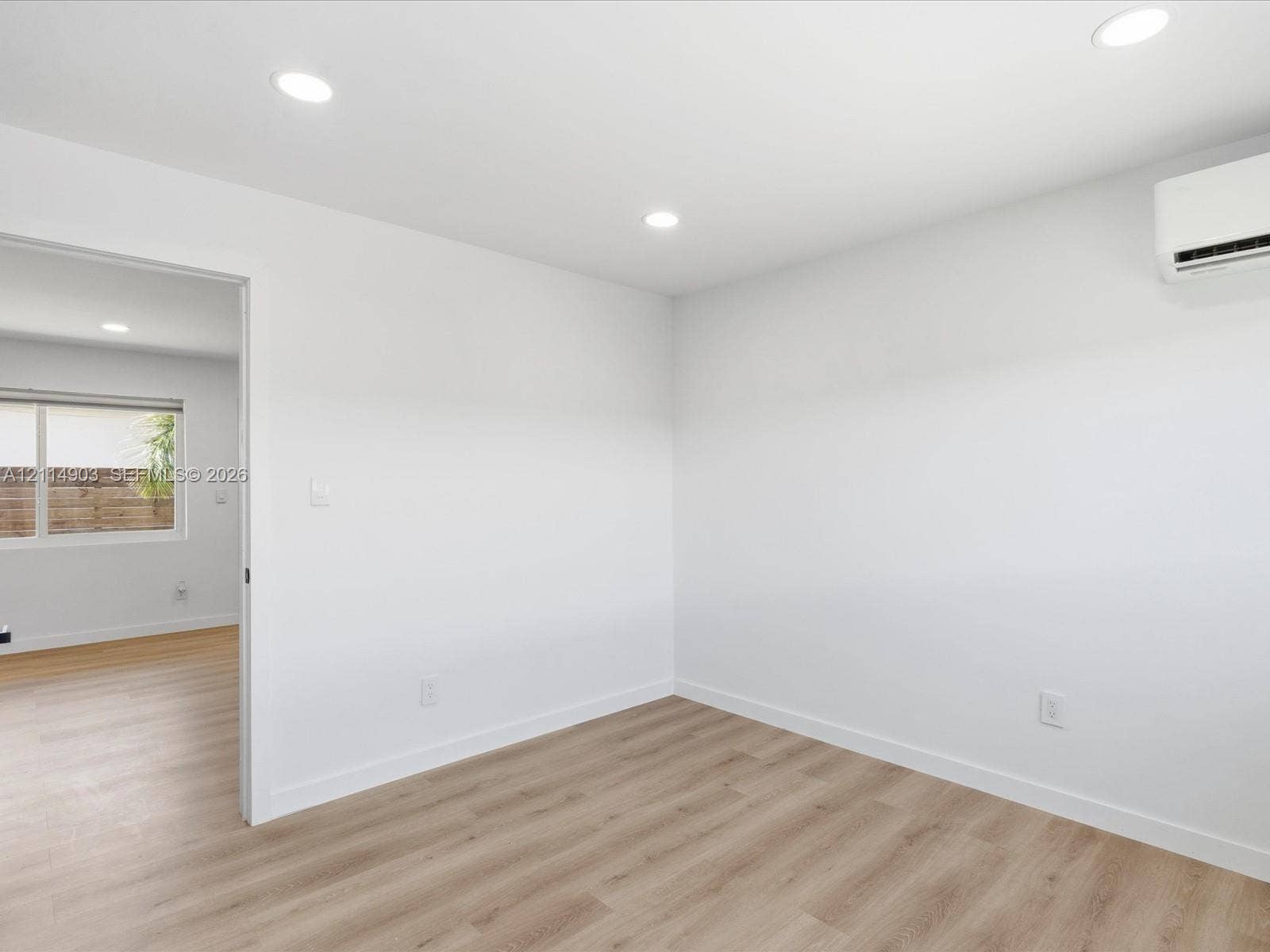 1129 NE 16th Avenue, #1, Fort Lauderdale, Fort Lauderdale, FL 33304 Interior space featuring wood-finish flooring, recessed lighting, and a wall-mounted ductless climate control unit