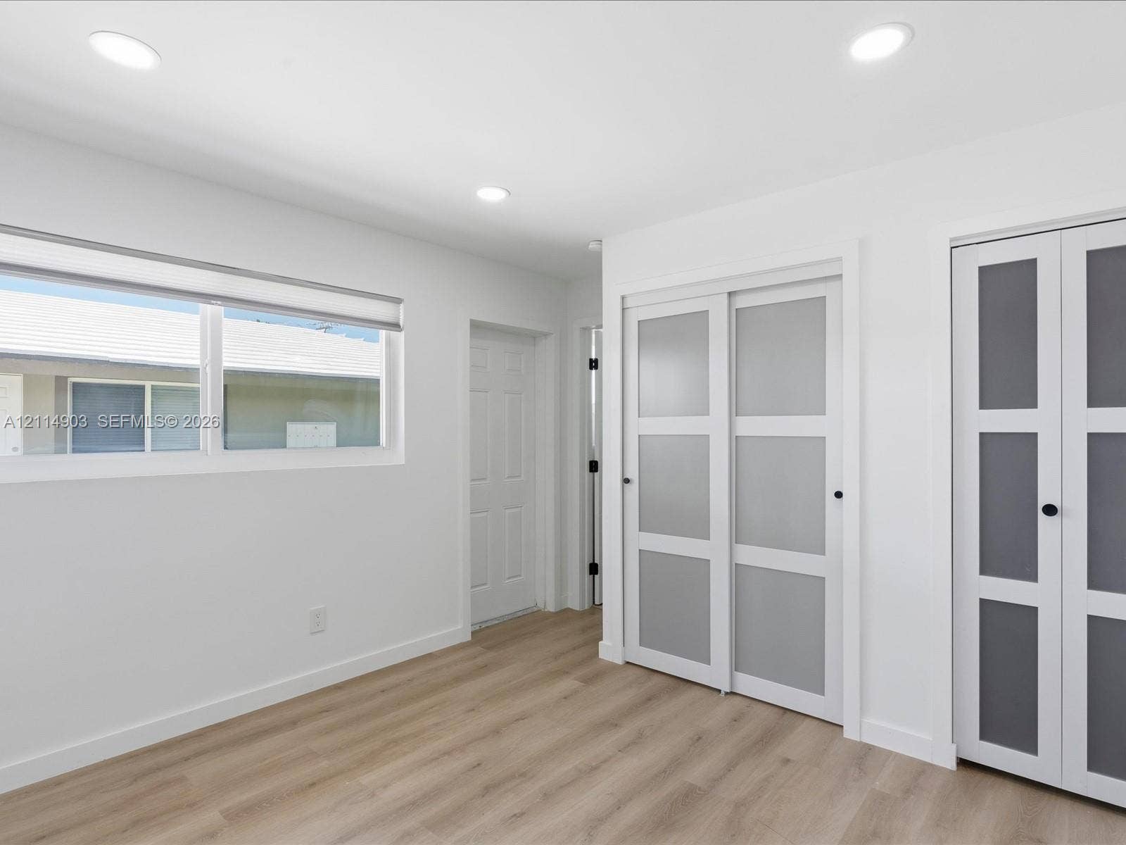 1129 NE 16th Avenue, #1, Fort Lauderdale, Fort Lauderdale, FL 33304 Wood-finish flooring, recessed lighting, and dual sets of frosted glass panel closet doors