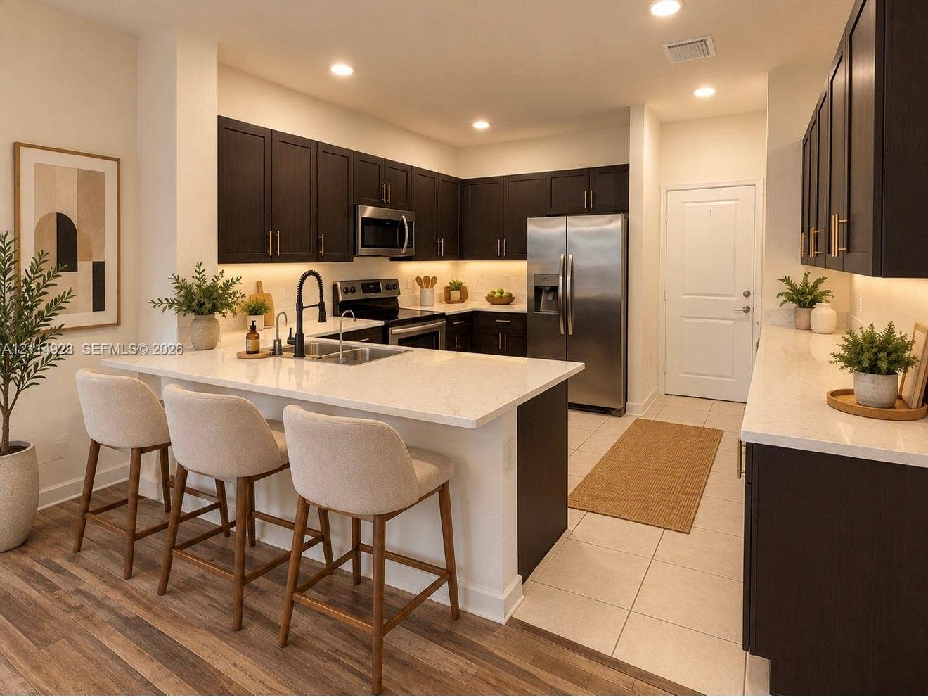 1411 SE 26th Road, Homestead, FL 33035 Kitchen featuring dark cabinetry, stone-finish countertops, stainless steel appliances, a center island with a built-in undermount sink, and recessed lighting