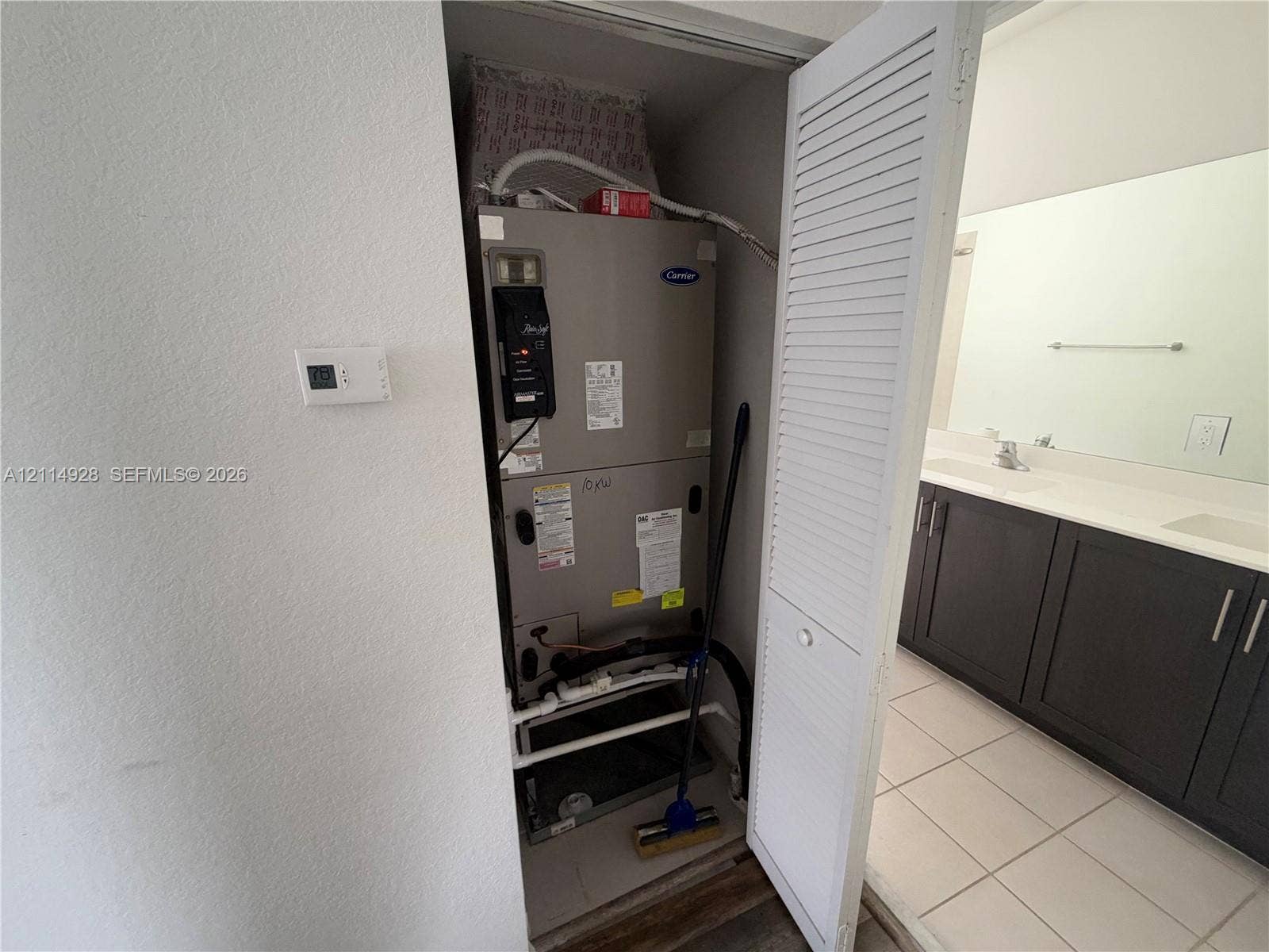 1411 SE 26th Road, Homestead, FL 33035 Carrier HVAC system housed in a utility closet with louvered door access