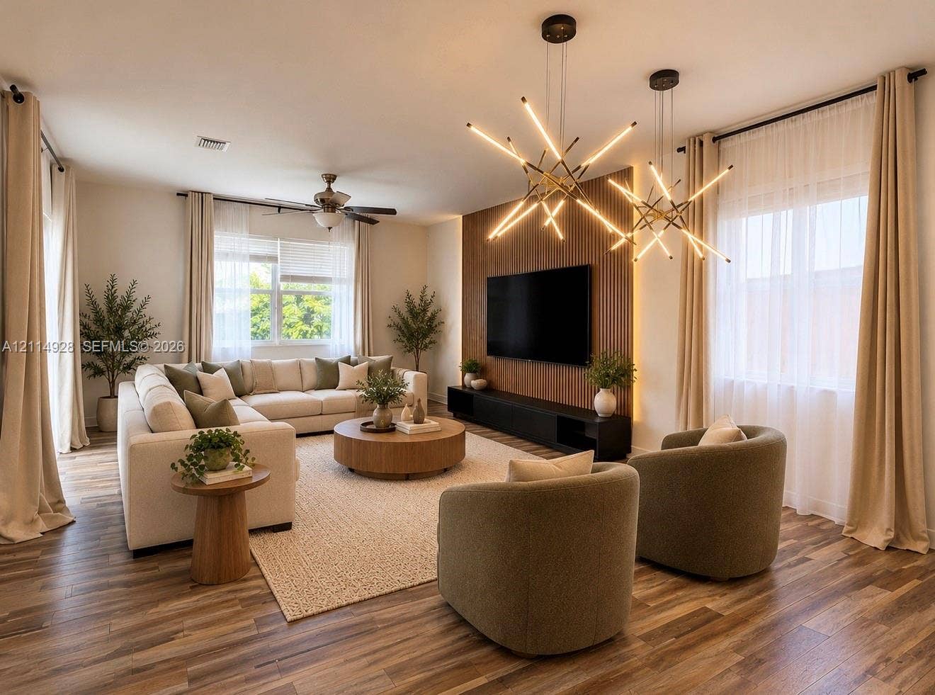 1411 SE 26th Road, Homestead, FL 33035 Living area featuring wood-finish flooring, dual starburst pendant light fixtures, and a vertical wood slat accent wall with integrated linear lighting