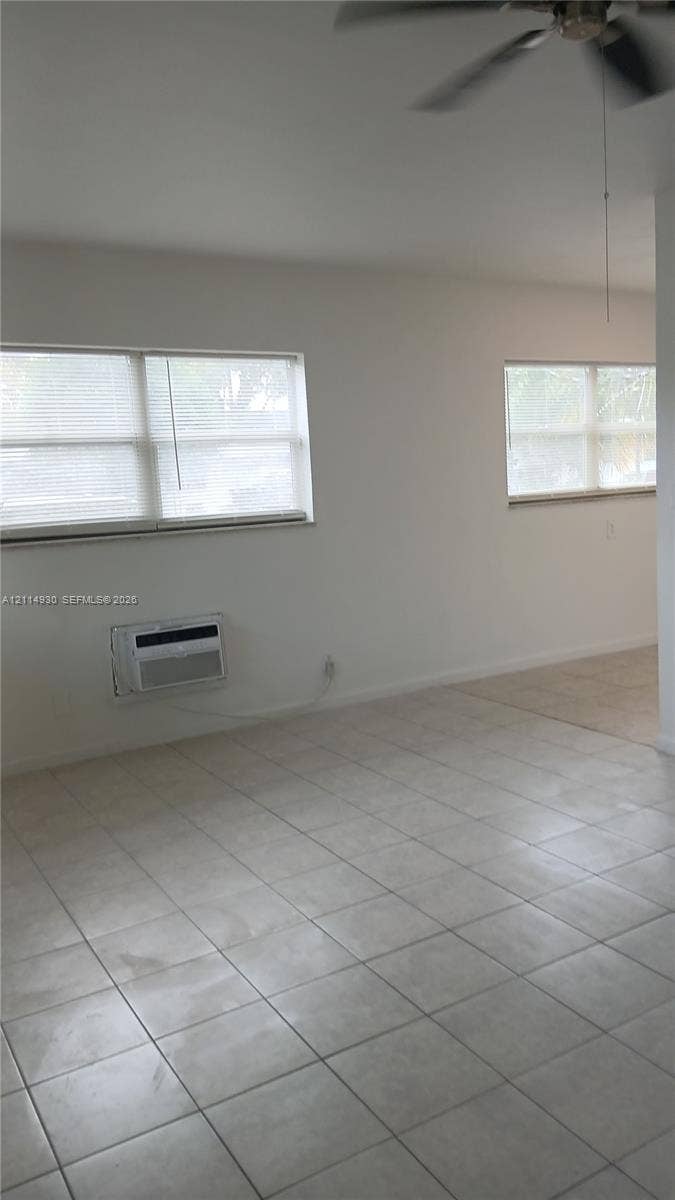 319 NE 2nd Street, #1, Hallandale Beach, Hallandale Beach, FL 33009 Ceramic tile flooring, dual windows with blinds, ceiling fan, and wall-mounted cooling unit
