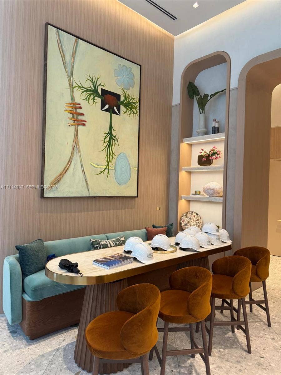 77 SE 5th Street, #607, Miami, FL 33141 Vertical wood-slat wall paneling, built-in recessed arched shelving with integrated lighting, and terrazzo flooring