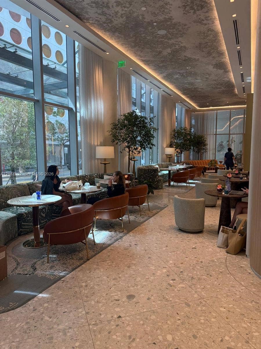 77 SE 5th Street, #607, Miami, FL 33141 Floor-to-ceiling windows, terrazzo flooring, recessed cove lighting, and decorative ceiling treatment