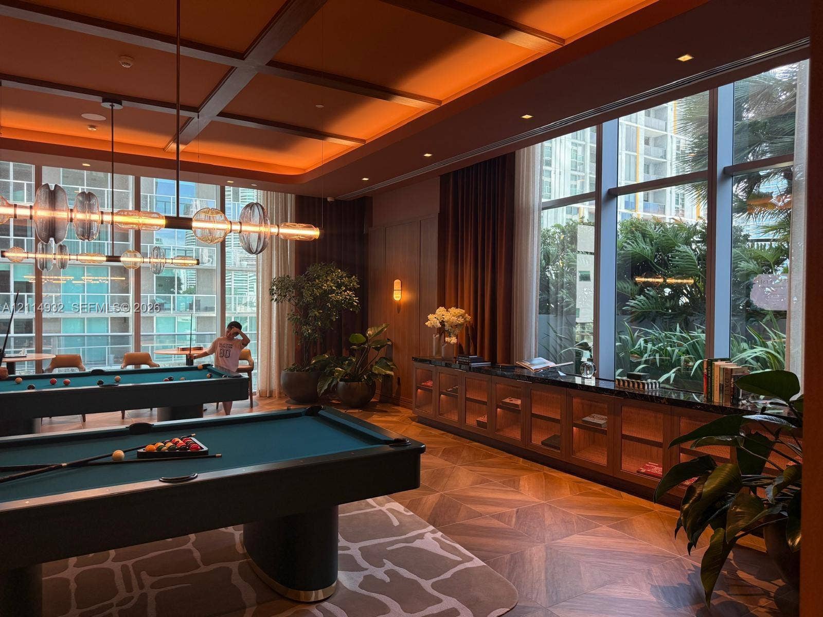 77 SE 5th Street, #607, Miami, FL 33141 Coffered ceiling featuring recessed lighting, expansive floor-to-ceiling windows, built-in lower cabinetry with stone surfacing, and intricate geometric-patterned wood-finish flooring