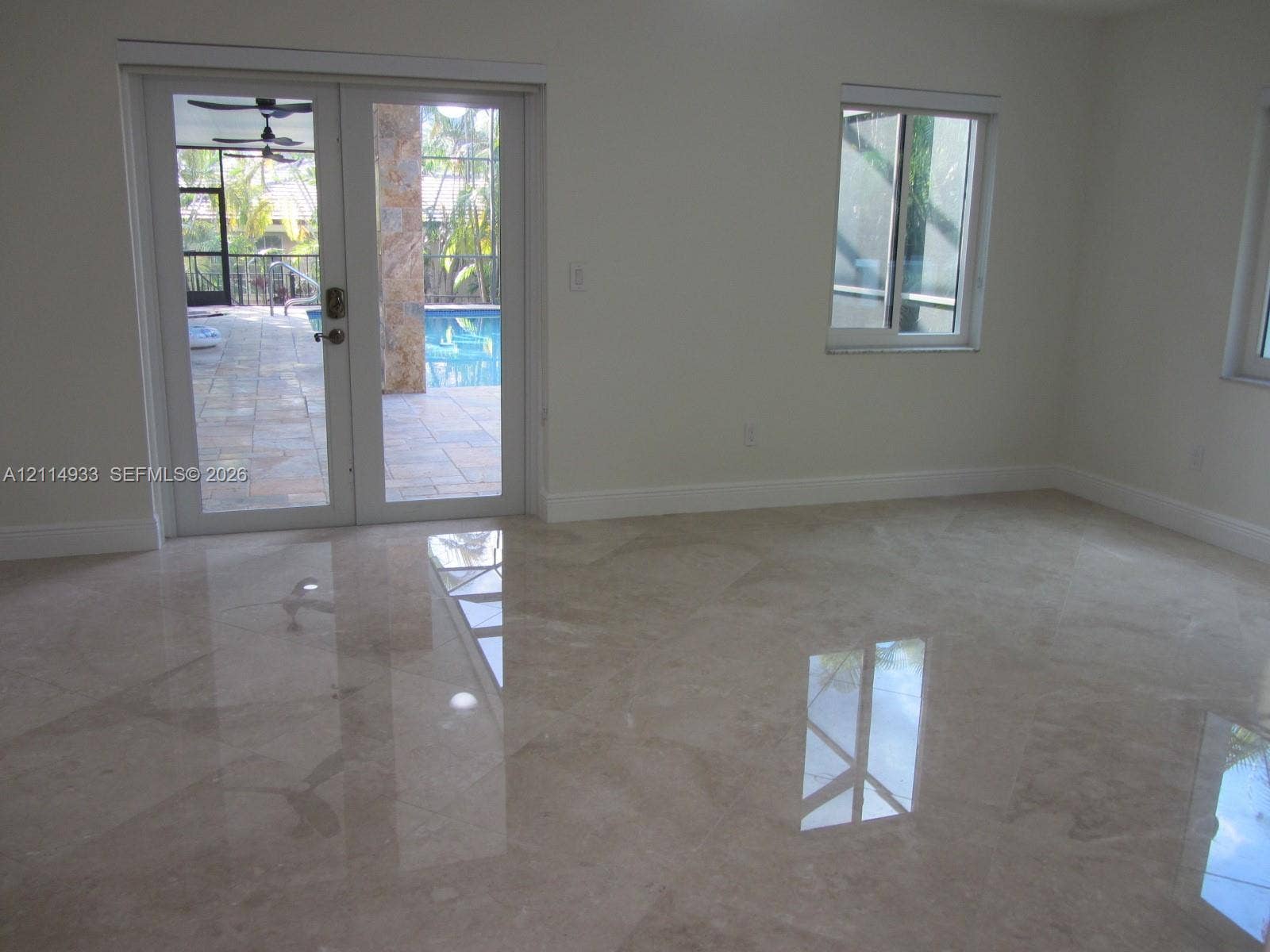 1001 Bella Vista Avenue, Coral Gables, Coral Gables, FL 33156 Polished stone flooring, double-pane sliding glass doors, and dual-pane windows