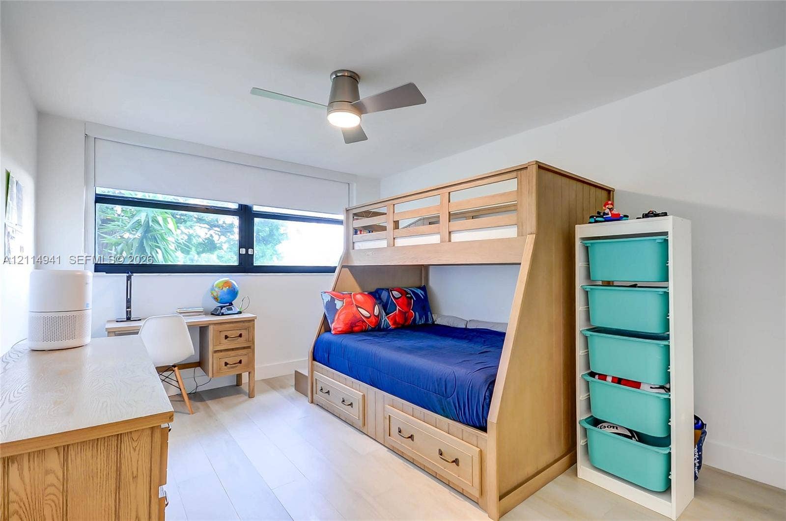 16175 Golf Club Road, #113, Weston, FL 33326 Neutral-toned room featuring wide-plank wood-finish flooring, a sleek horizontal window with a black frame, and a modern metal ceiling fan with integrated lighting