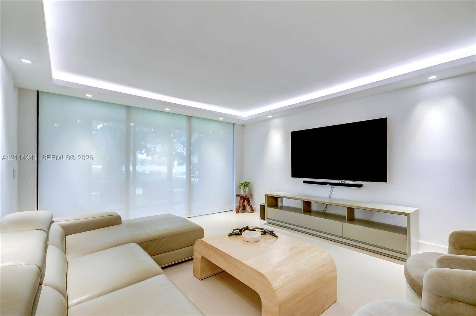 16175 Golf Club Road, #113, Weston, FL 33326 Tray ceiling featuring recessed LED lighting, expansive floor-to-ceiling glass wall panels, smooth finish flooring, and integrated wall-mounted lighting