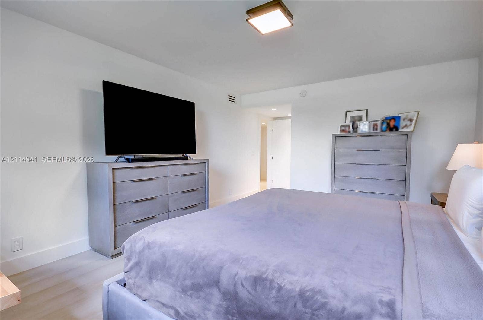 16175 Golf Club Road, #113, Weston, FL 33326 Neutral color palette featuring light-toned wood-finish flooring and a ceiling-mounted square light fixture