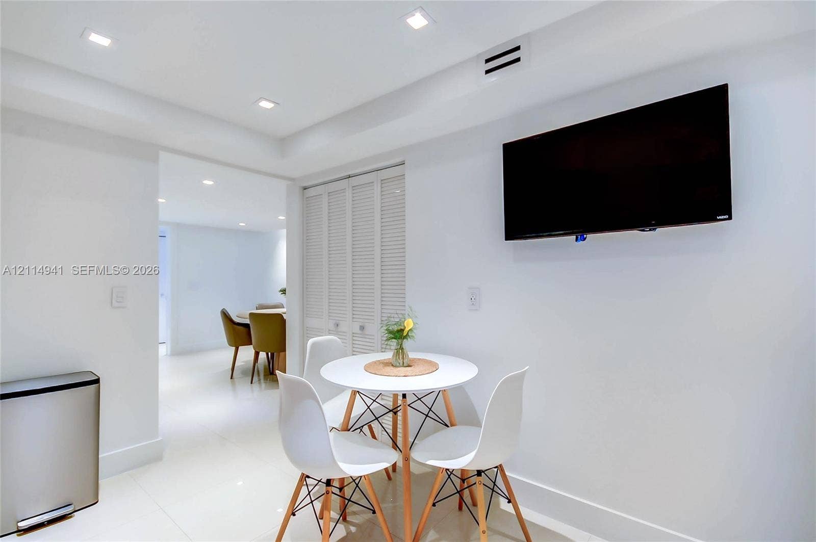 16175 Golf Club Road, #113, Weston, FL 33326 Recessed ceiling lighting, glossy tile flooring, and bi-fold louvered closet doors