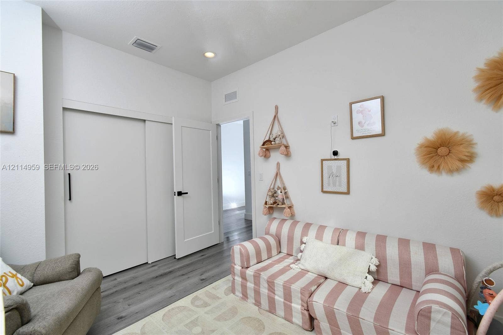 8017 Sunrise Circle, Labelle, FL 33935 Wood-finish flooring, high ceilings, recessed lighting, and a white interior door featuring matte black hardware