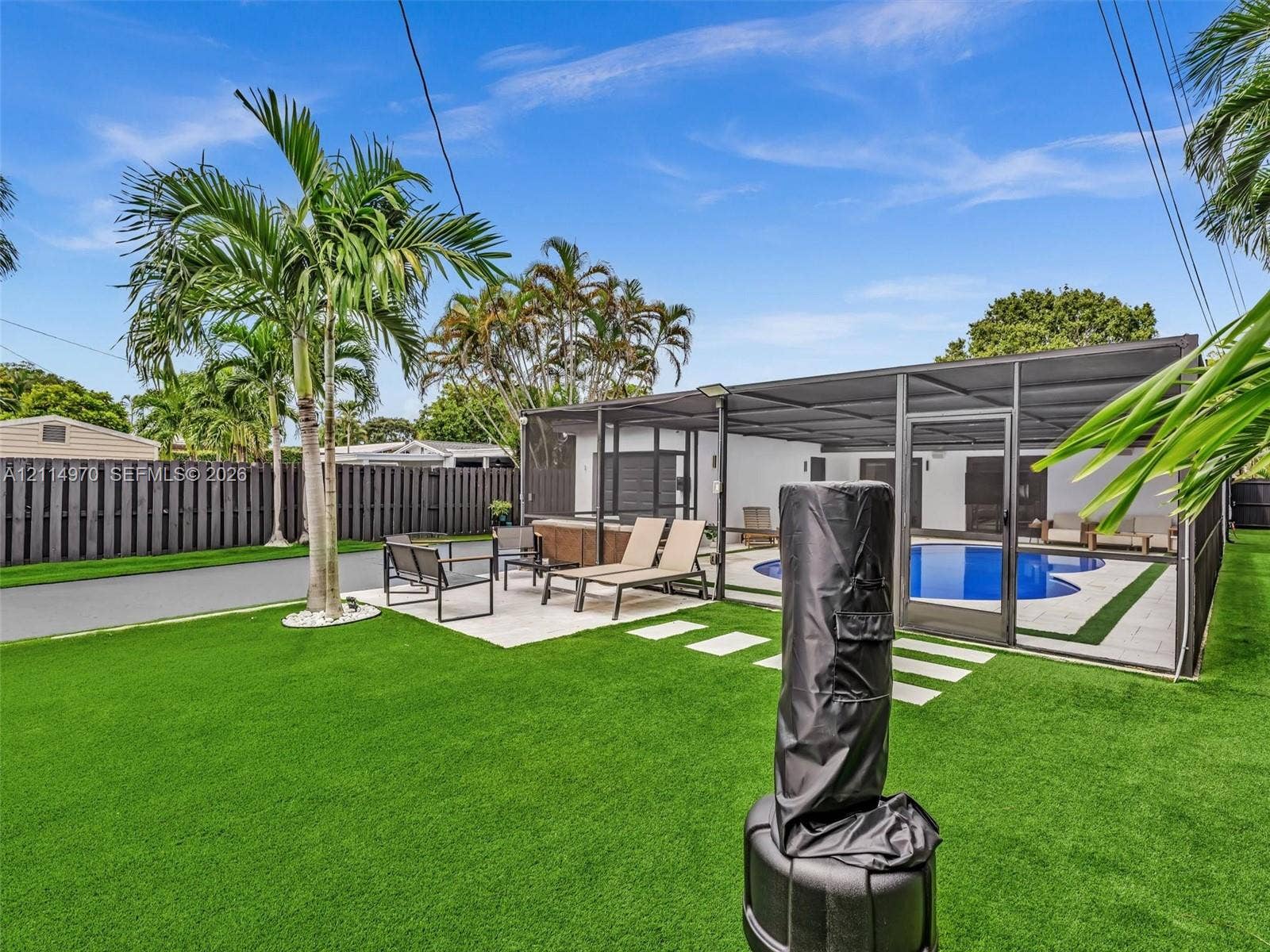 4204 Van Buren Street, Hollywood, Hollywood, FL 33021 Backyard featuring synthetic turf, screened-in swimming pool, paved patio, and privacy fencing