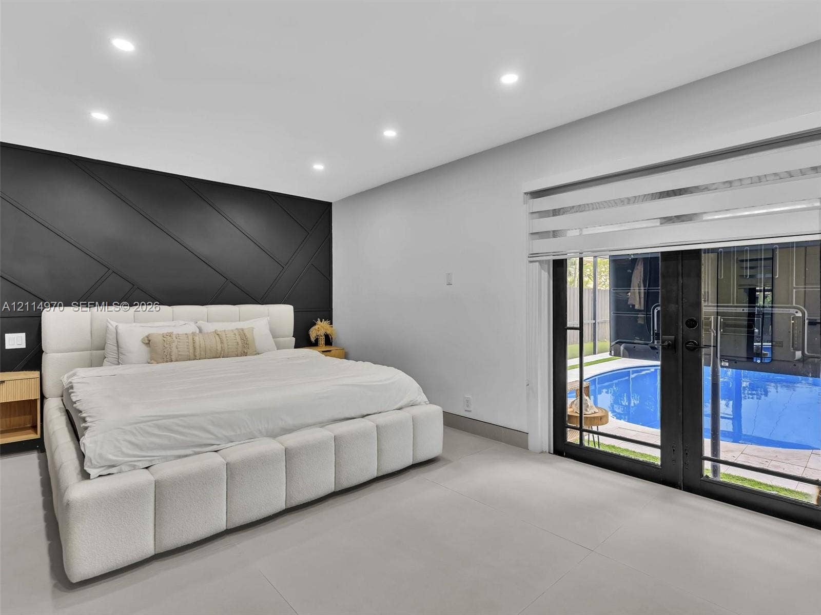 4204 Van Buren Street, Hollywood, Hollywood, FL 33021 Geometric black accent wall, recessed ceiling lighting, large-format tile flooring, and glass-paneled double doors featuring an exterior swimming pool