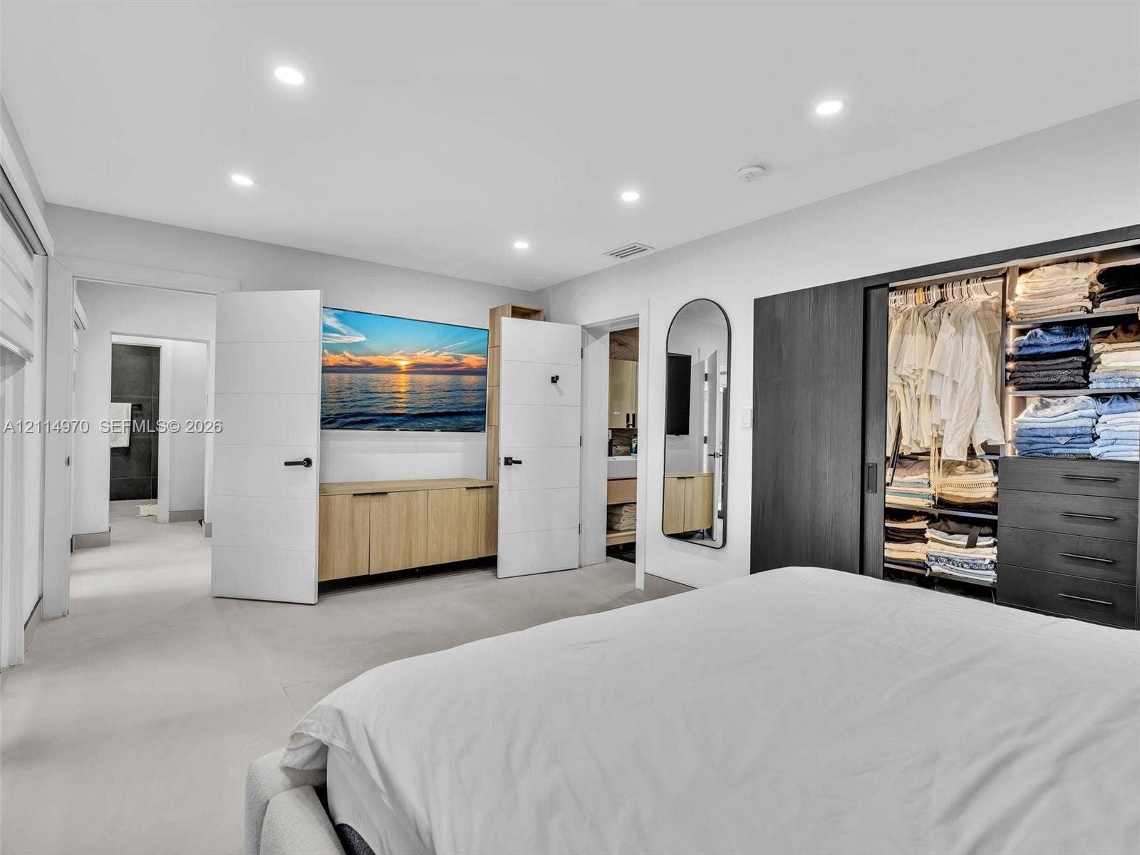 4204 Van Buren Street, Hollywood, Hollywood, FL 33021 Recessed lighting, built-in light-wood cabinetry, matte black hardware, and floor-to-ceiling closet with dark-finish sliding doors