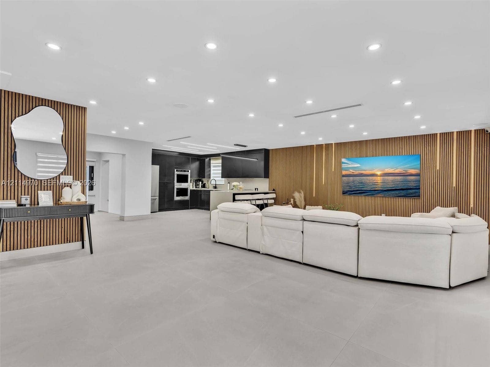 4204 Van Buren Street, Hollywood, Hollywood, FL 33021 Open-concept interior featuring large-format tile flooring, recessed ceiling lighting, and custom wood-slat accent walls