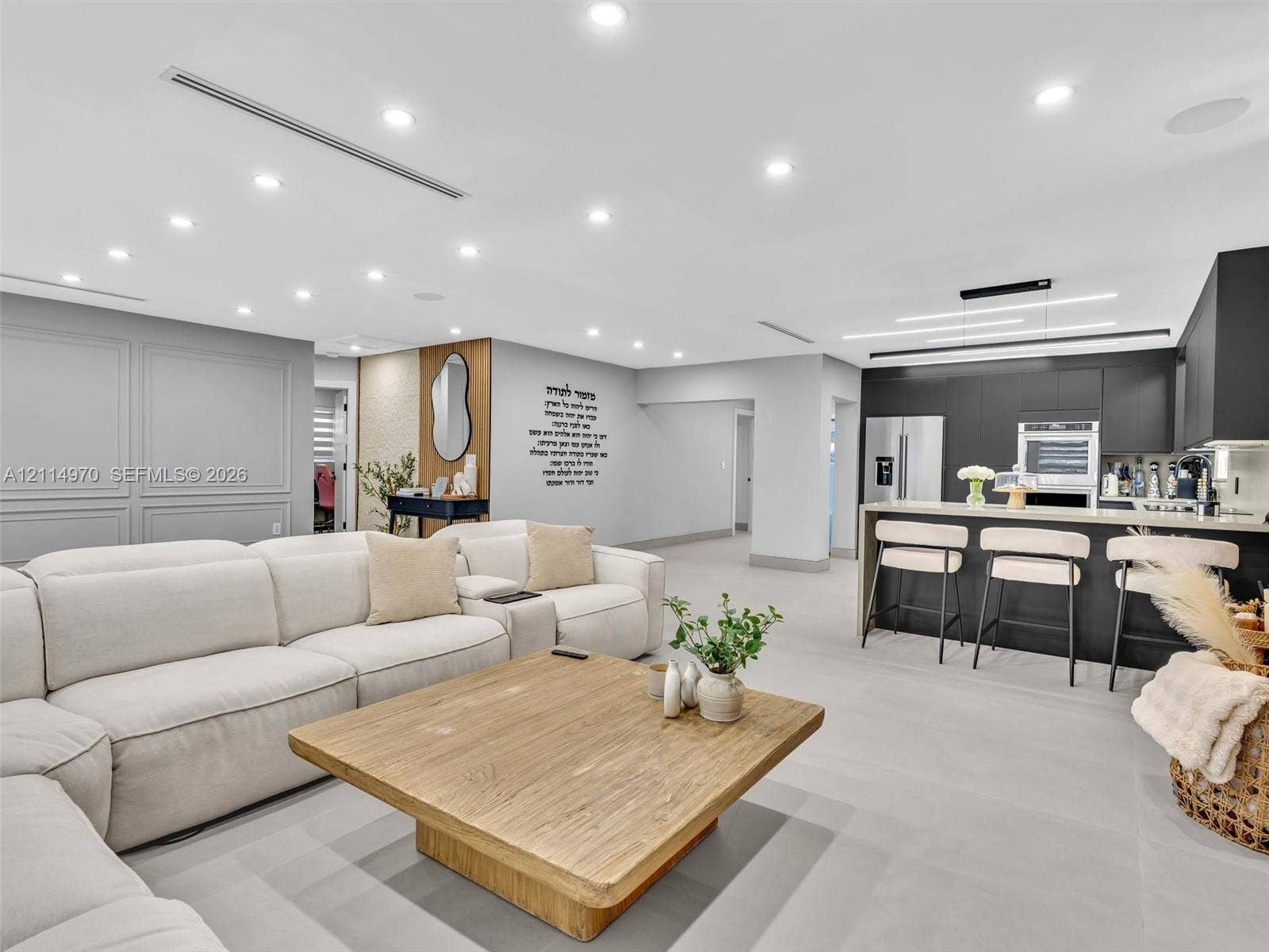 4204 Van Buren Street, Hollywood, Hollywood, FL 33021 Open-concept interior featuring recessed lighting, matte black cabinetry, stone-surfaced kitchen island, wood-finish flooring, and wall paneling