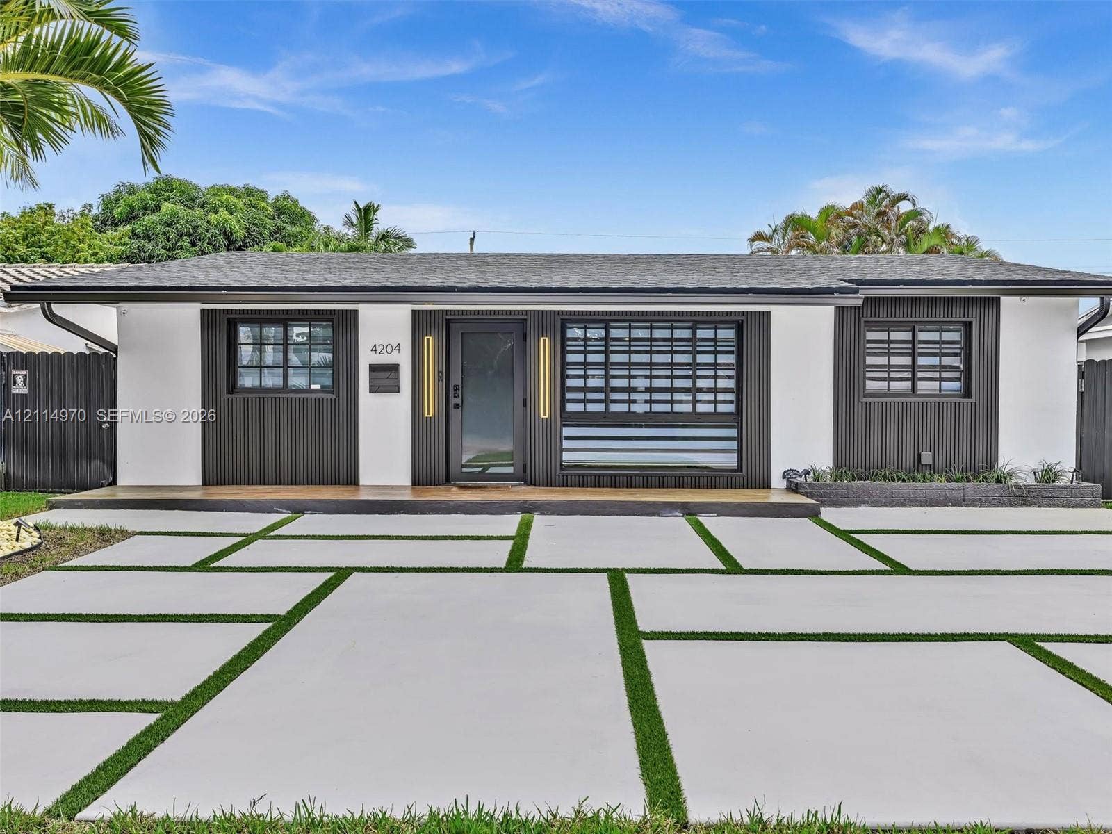4204 Van Buren Street, Hollywood, Hollywood, FL 33021 Single-story exterior featuring a high-contrast facade with vertical wood-slat siding and a covered front landing