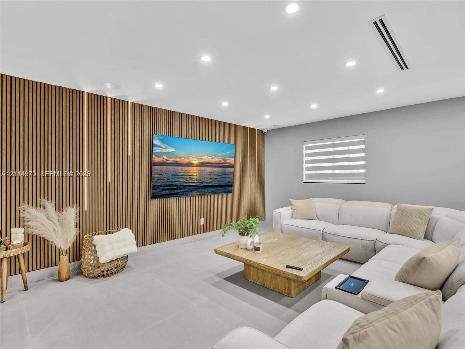 4204 Van Buren Street, Hollywood, Hollywood, FL 33021 Vertical wood-slat accent wall with integrated LED lighting, neutral large-format tile flooring, recessed ceiling lighting, and dual-roller window shade