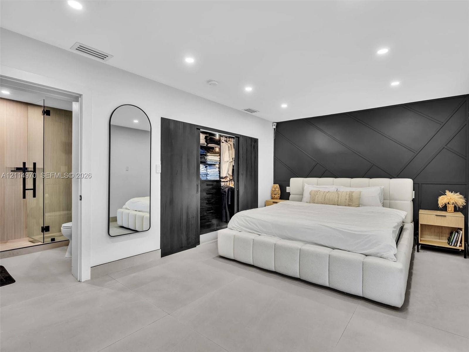 4204 Van Buren Street, Hollywood, Hollywood, FL 33021 Geometric-patterned accent wall, sliding-door walk-in closet, recessed ceiling lighting, and large-format tile flooring