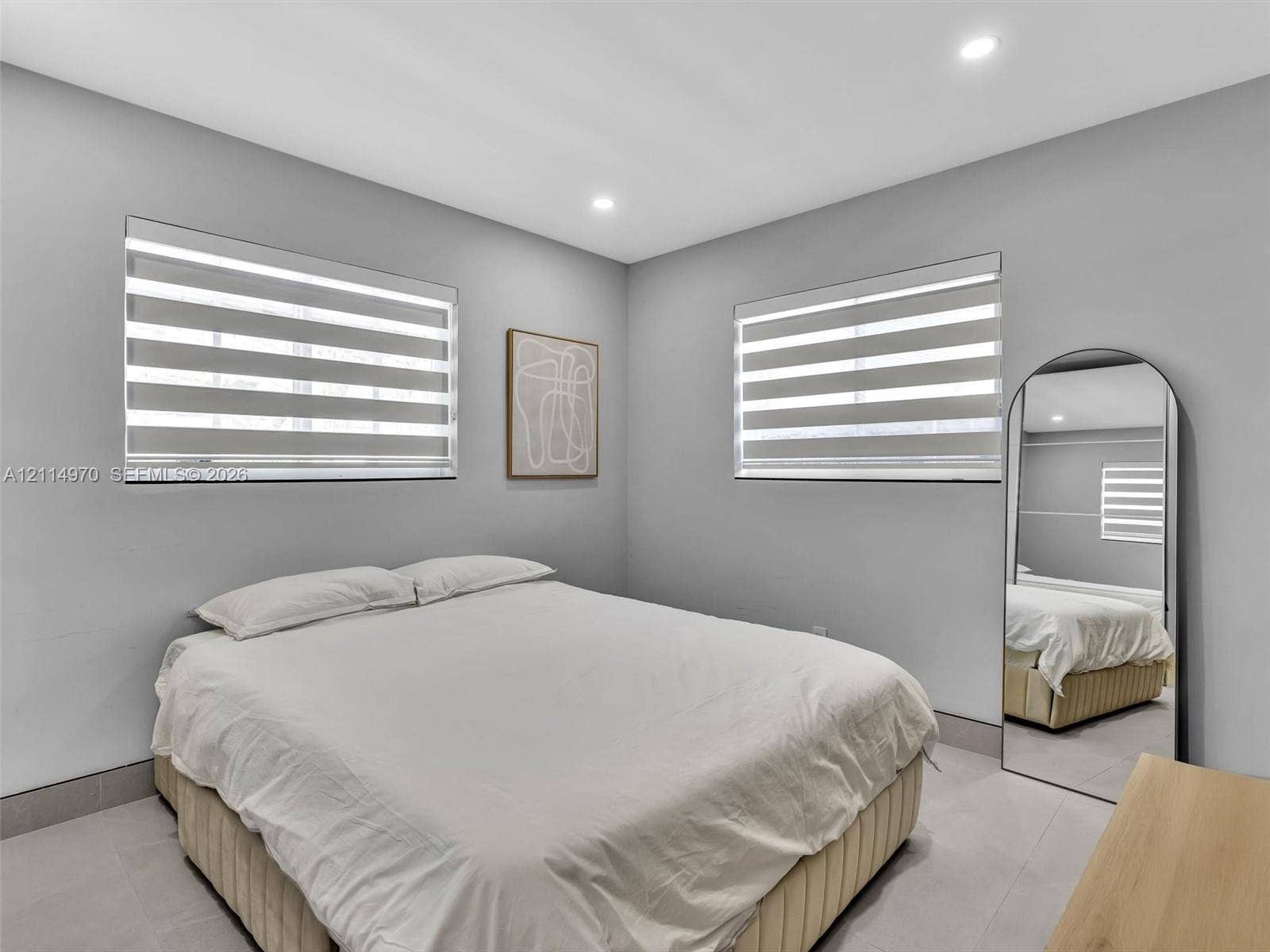 4204 Van Buren Street, Hollywood, Hollywood, FL 33021 Neutral-toned interior space featuring light-colored tile flooring, recessed ceiling lighting, and dual windows equipped with horizontal light-filtering roller shades
