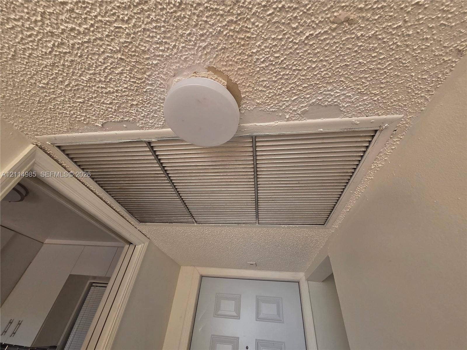 9441 Live Oak Place, #308, Davie, Davie, FL 33324 Flush-mount ceiling lighting fixture, textured ceiling finish, and louvered HVAC return grille