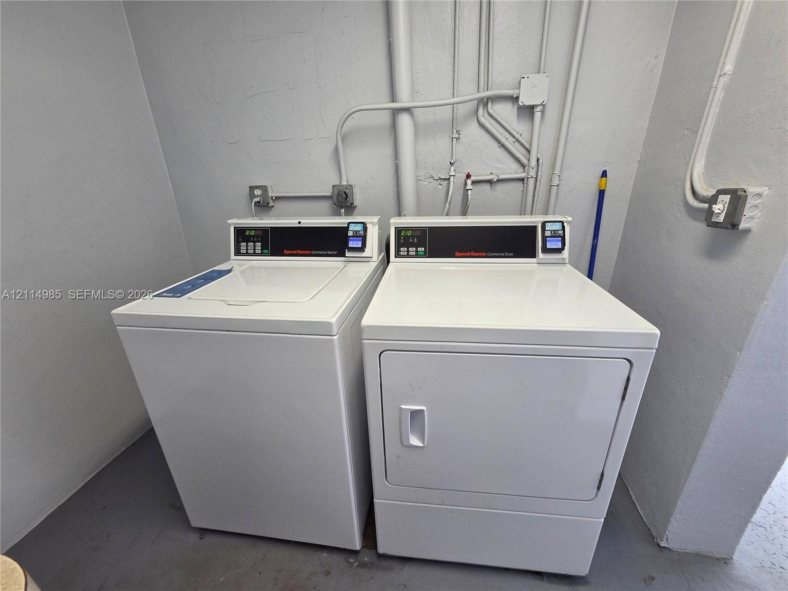 9441 Live Oak Place, #308, Davie, Davie, FL 33324 Laundry area featuring top-load washing machine and front-load dryer with white exterior finishes